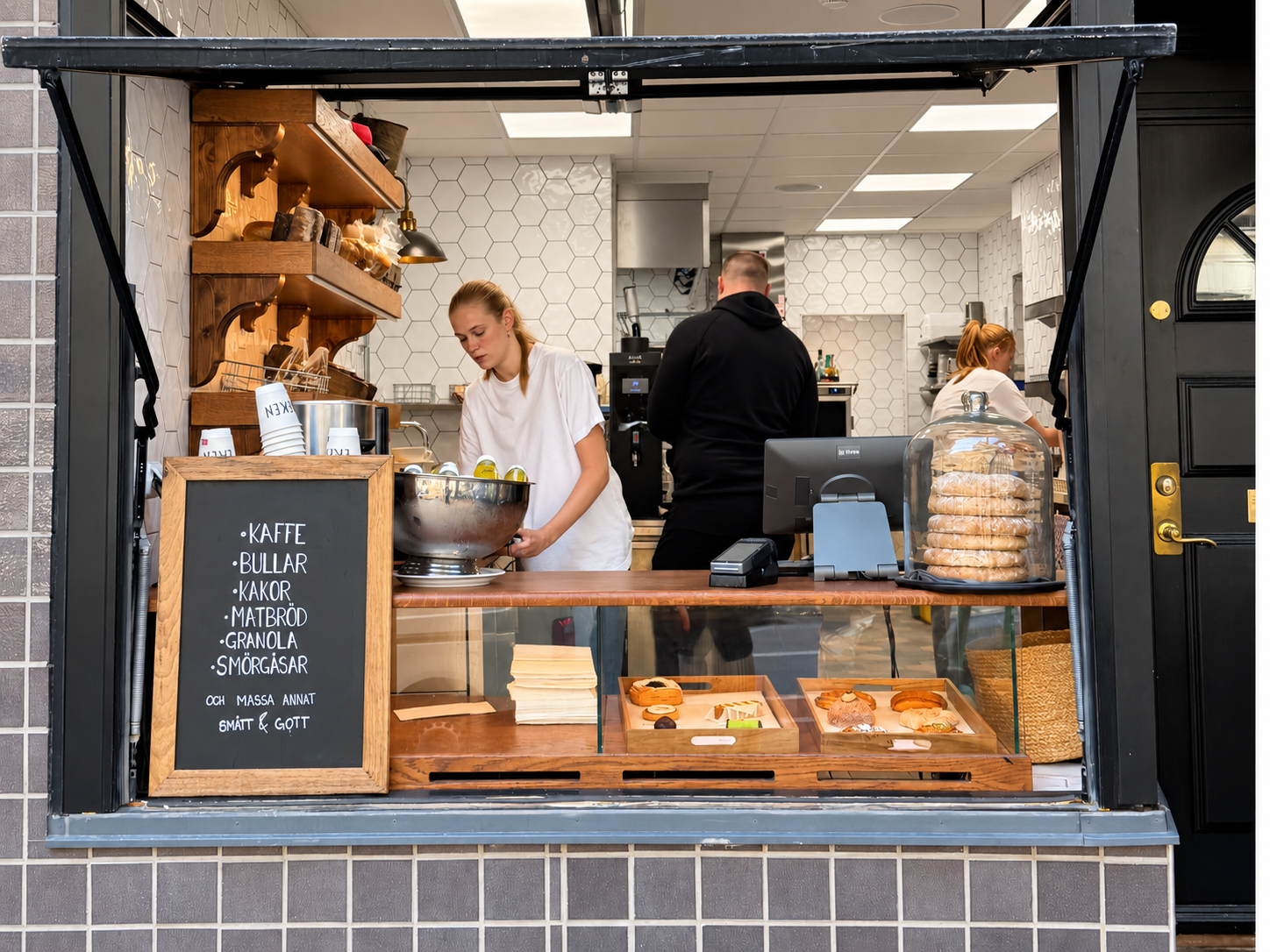 Bakers working inside Eken’s street-facing café counter